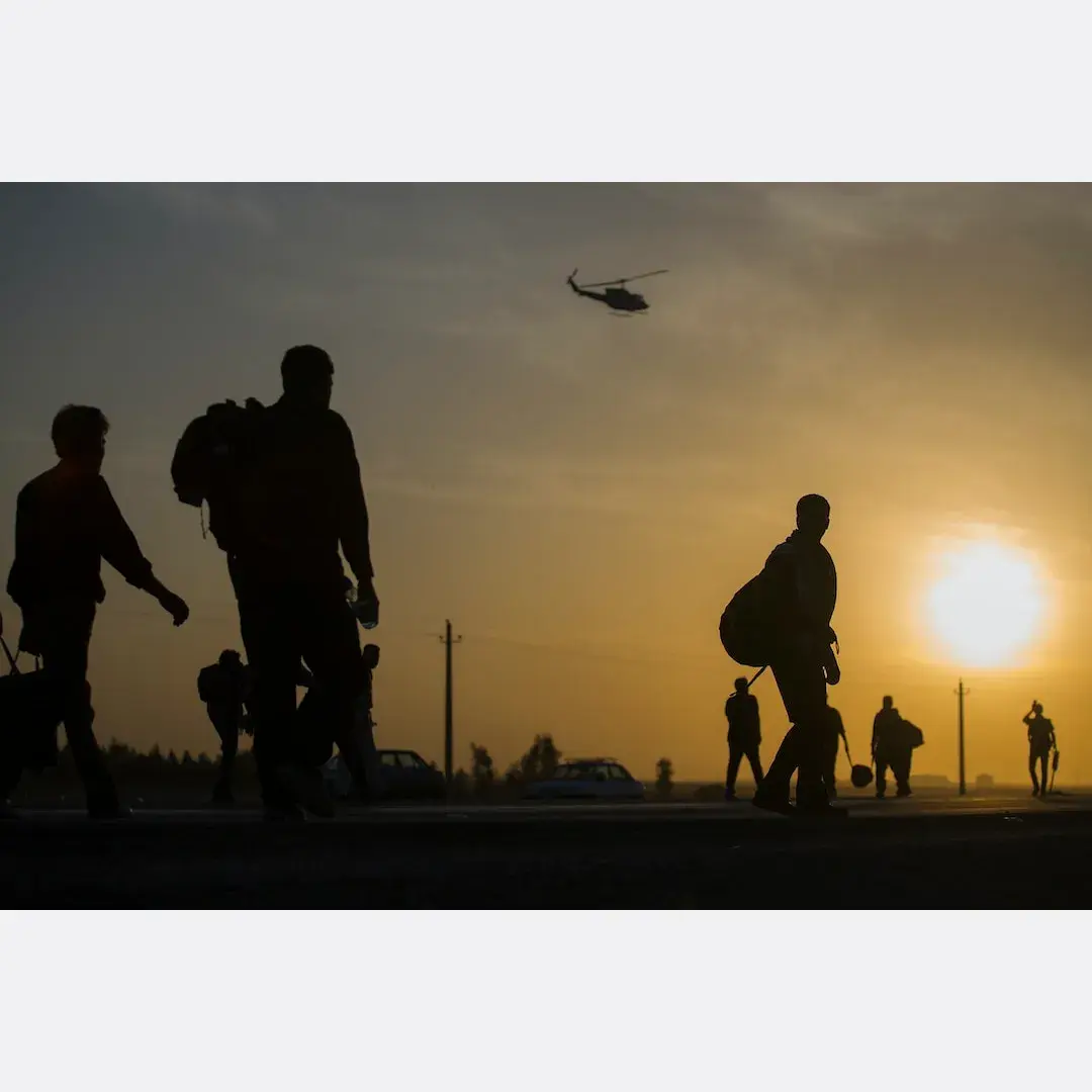Silhouettes of Australian soldiers walking at sunset