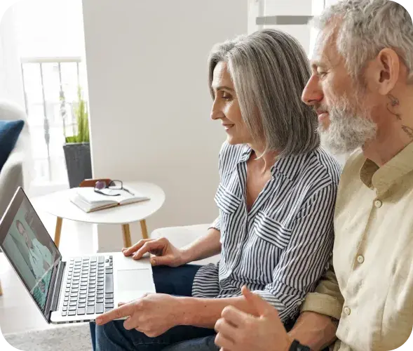 Two people reading a guide together at a kitchen table
