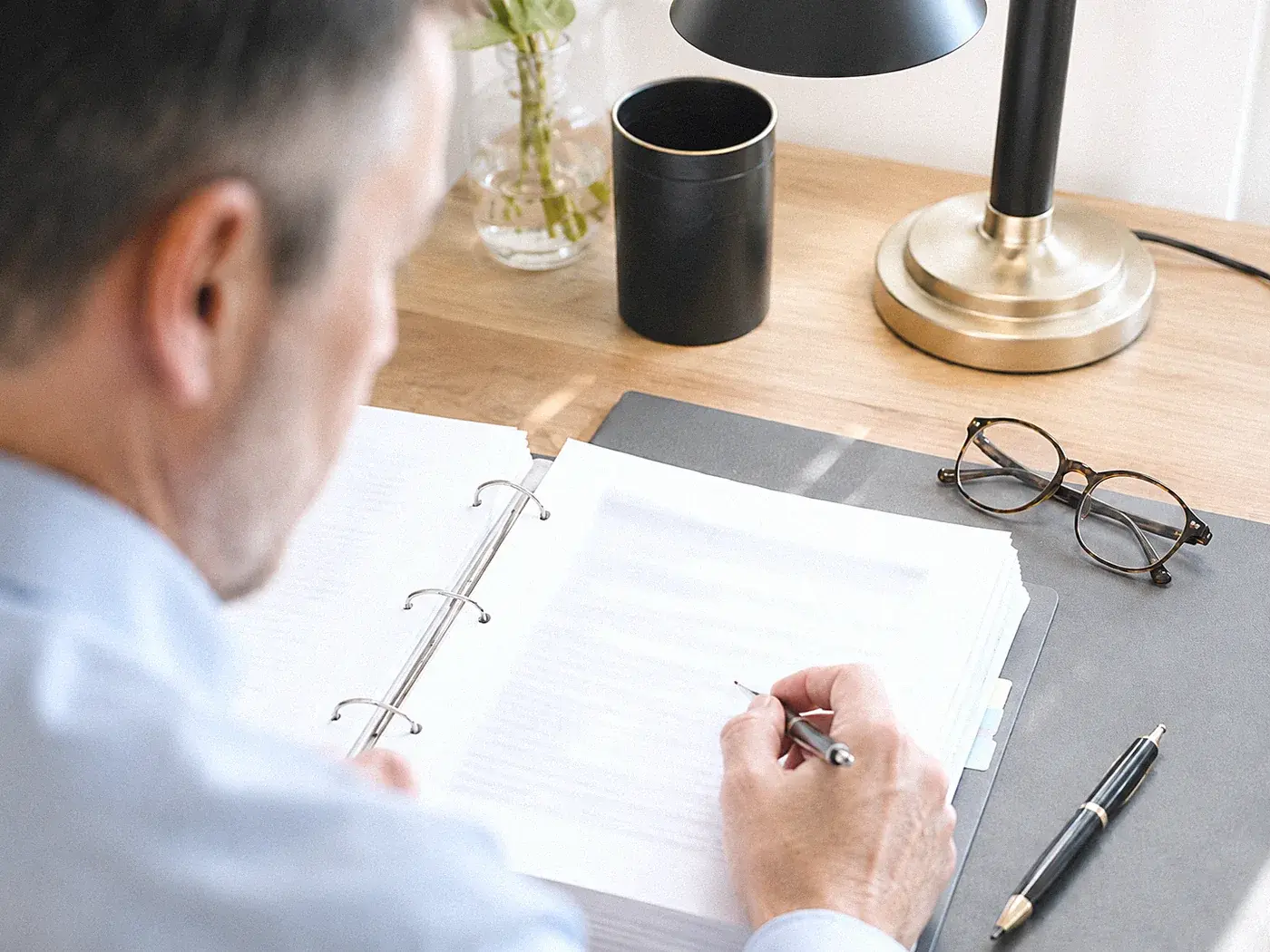 Man reviewing a folder of medical records