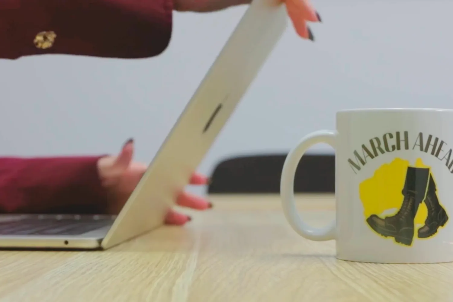A March Ahead mug beside a laptop in the East Brisbane clinic