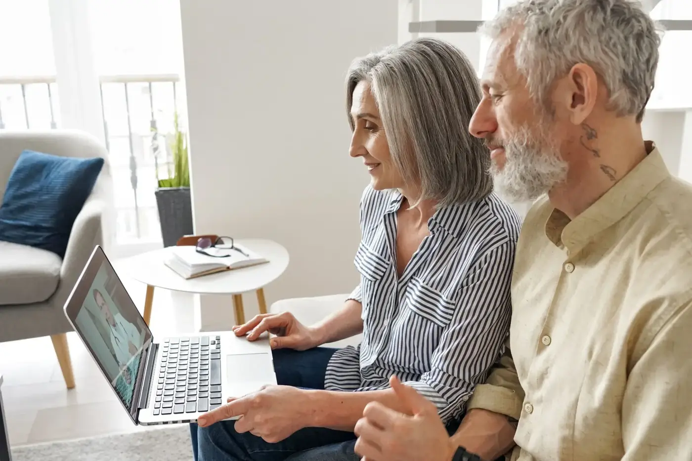 Couple at home talking with a clinician over a video call