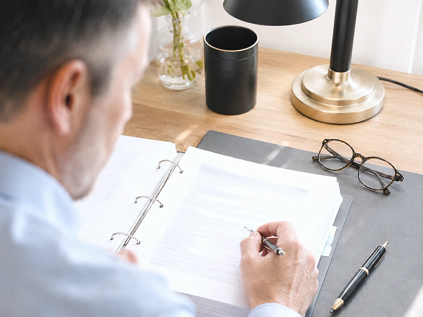 Psychiatrist carefully reviewing a folder of veteran medical records